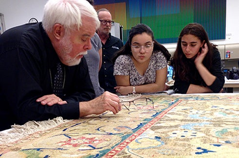 Art history students examine Islamic textiles